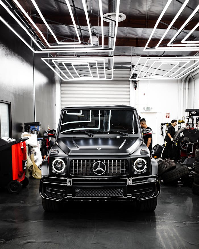 Front view of a luxury Mercedes-Benz SUV parked inside a sleek modern garage.